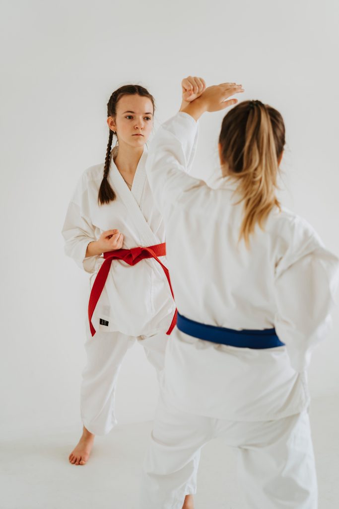 Two karate practitioners practising a defensive blocking technique